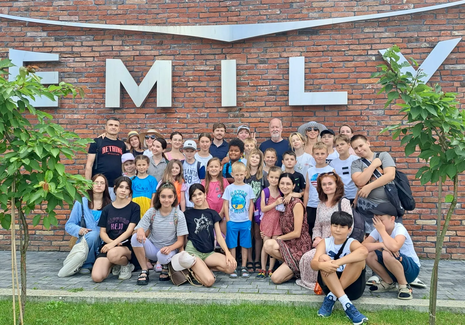 A large group of campers and volunteers gathered together on a city excursion